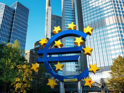 Close view of The Euro-Skulptur with multiple skyscrapers on the background in Frankfurt downtown, Germany. Flag of Ukraine and blood on it